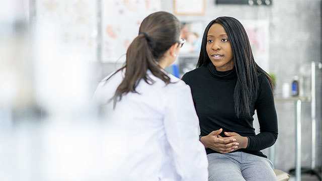 Woman talking to healthcare provider.