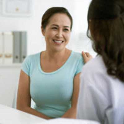 Woman talking to health care provider.