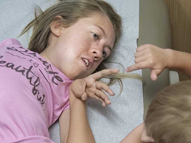 Two children touching hands.