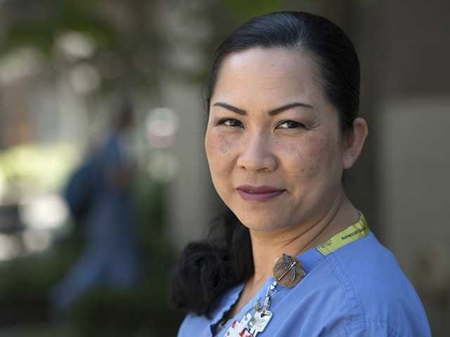 Female health provider wearing scrubs.