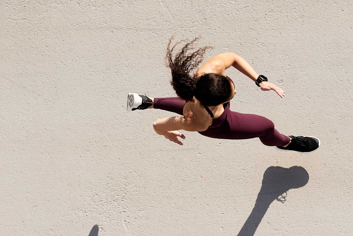 Woman running down pavement