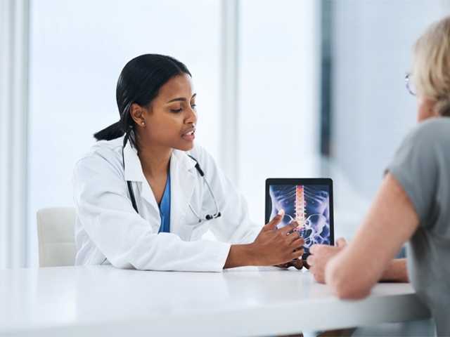 Medical professional at table with woman.