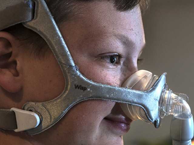 boy wearing cpap mask