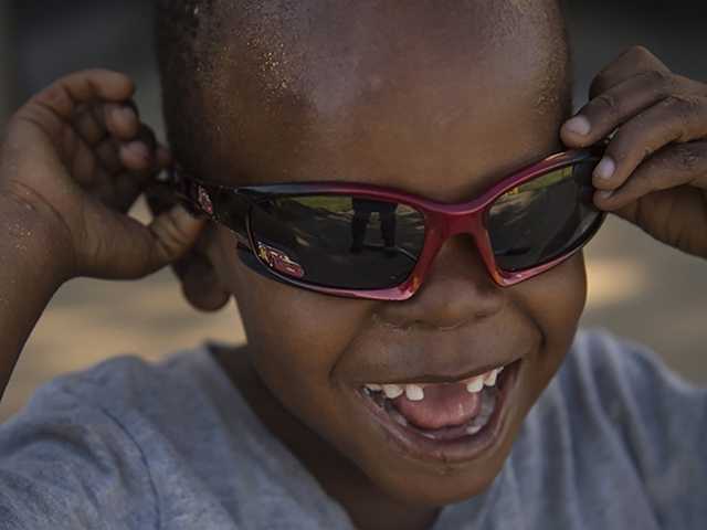 Headshot of boy smiling and wearing sunglasses