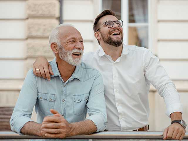 Two men visiting outside.