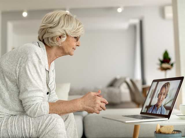 Woman sitting in front of laptop.