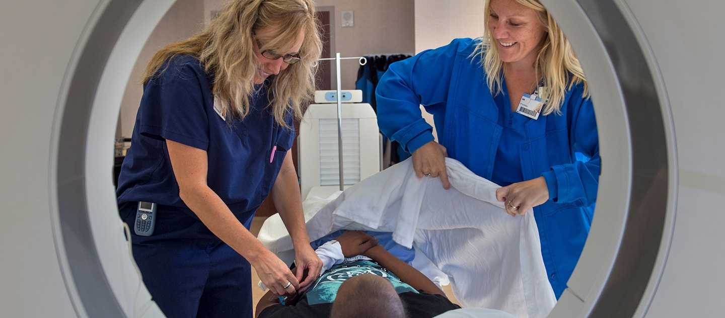 Radiology professionals assisting a patient getting an MRI