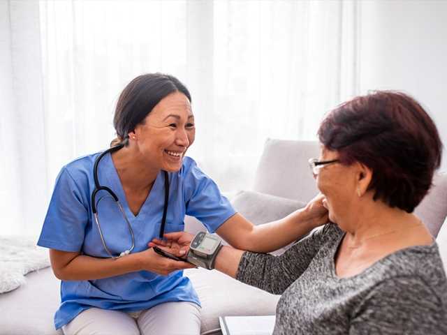 Nurse assisting patient.