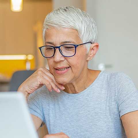 Woman looking at laptop.