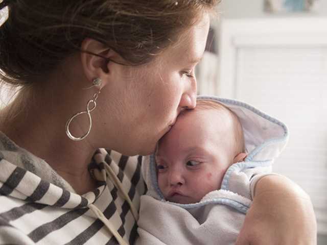 mother kissing child