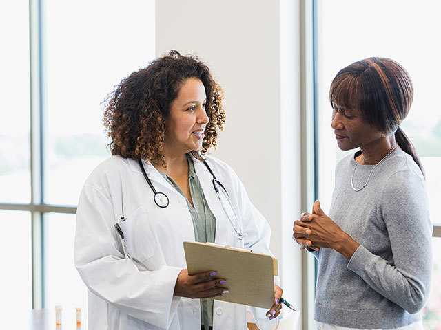 Woman talking to healthcare provider.