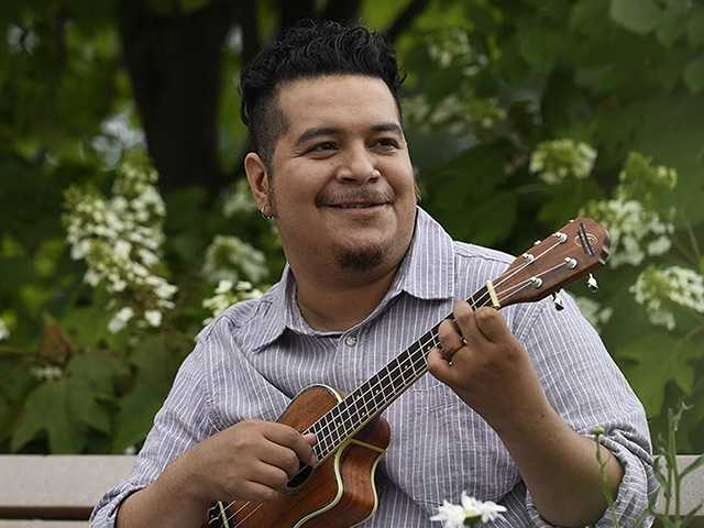 Miguel playing a guitar