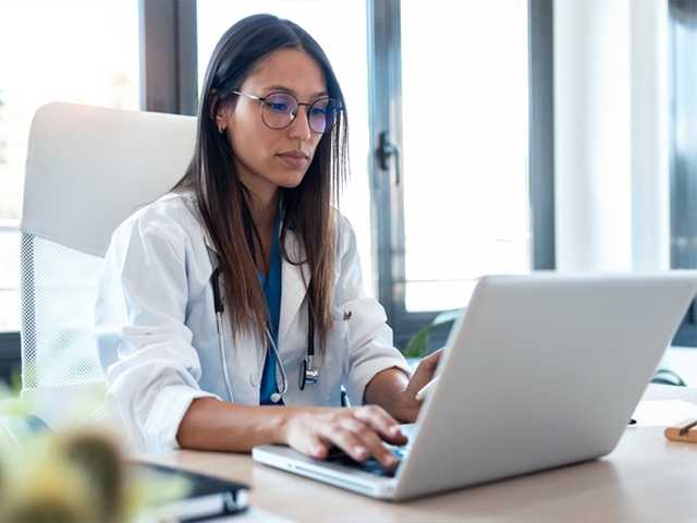 Medical providers looking at laptop.