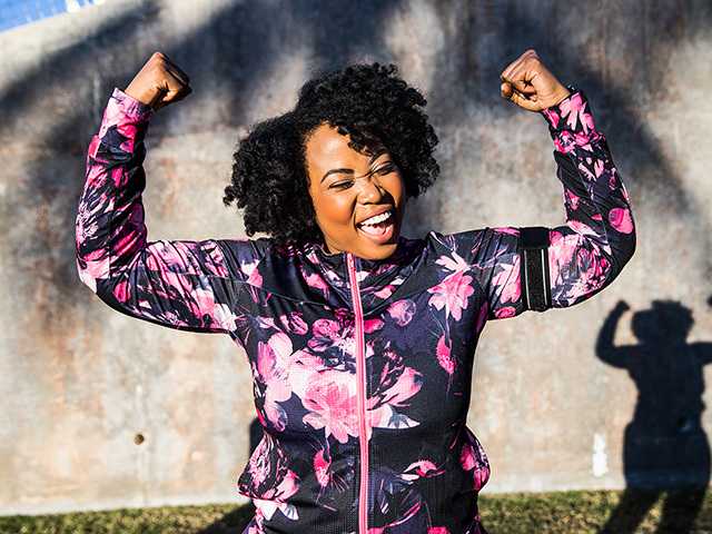 fit woman smiling and flexing